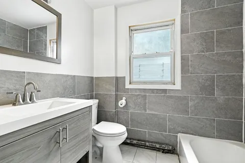 a bathroom with a sink a toilet and window