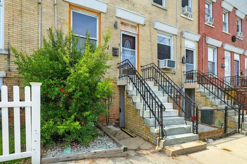 a picture of wall with a white bench and a picture