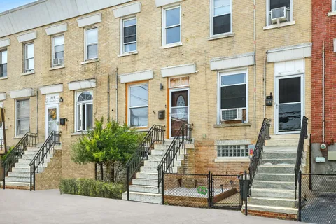 a picture of a bench in front of a wall