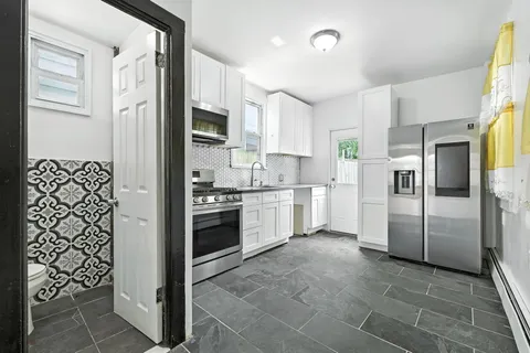 a kitchen with stainless steel appliances a refrigerator sink and cabinets