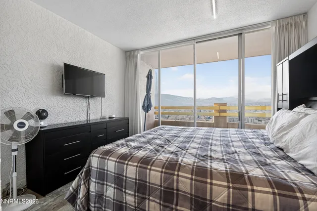 a bedroom with a bed and painting on the wall