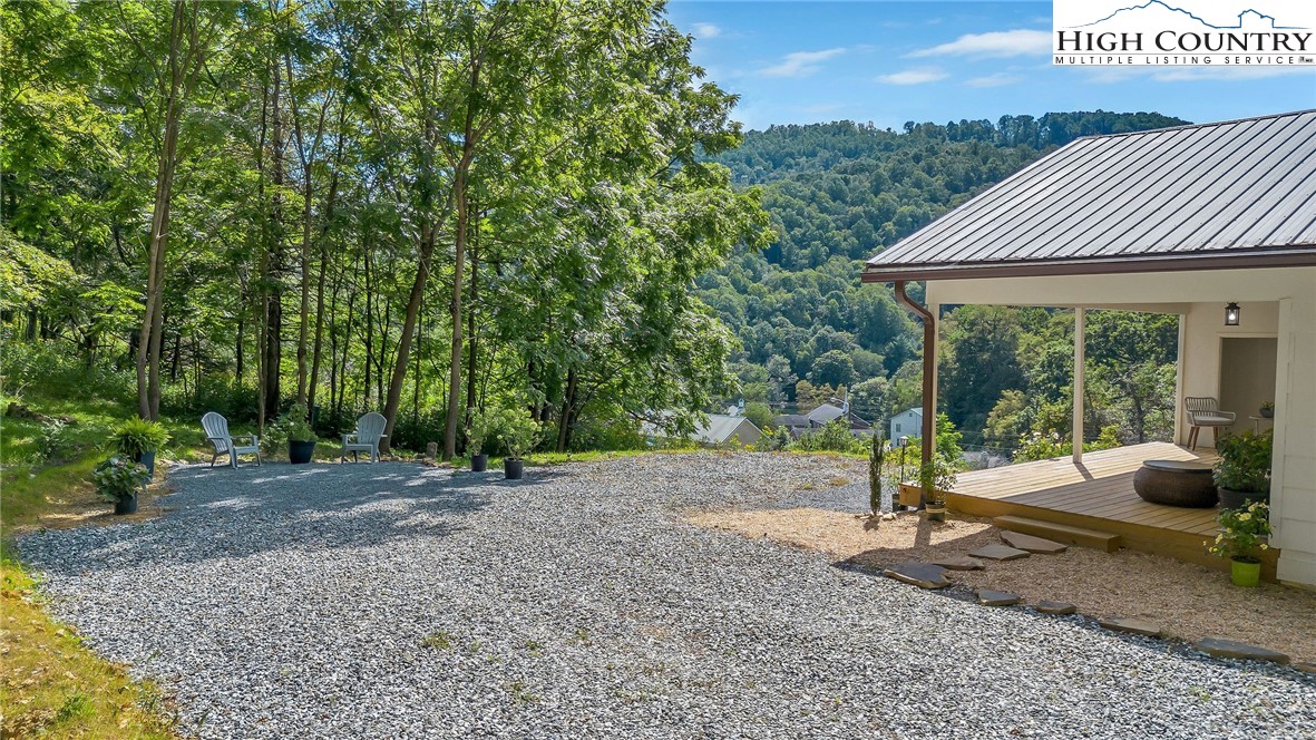 393 Carter Miller Road Todd, NC 28684 - Photo 11 of 50 a backyard of a house with seating space