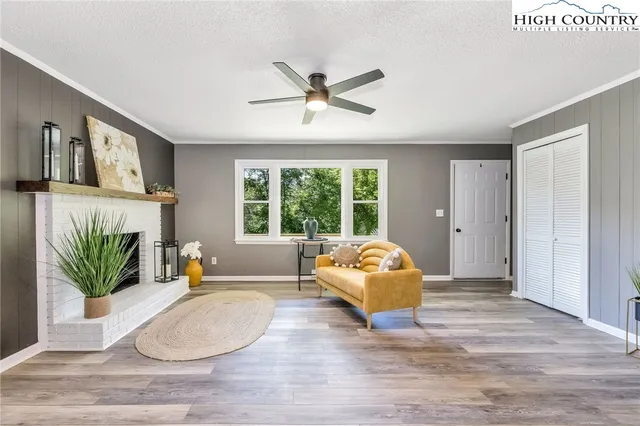 a living room with a bed furniture and a large window