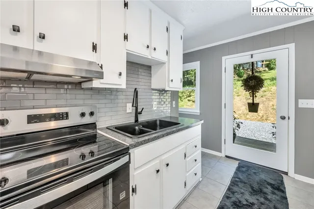 a kitchen with stainless steel appliances white cabinets and a stove