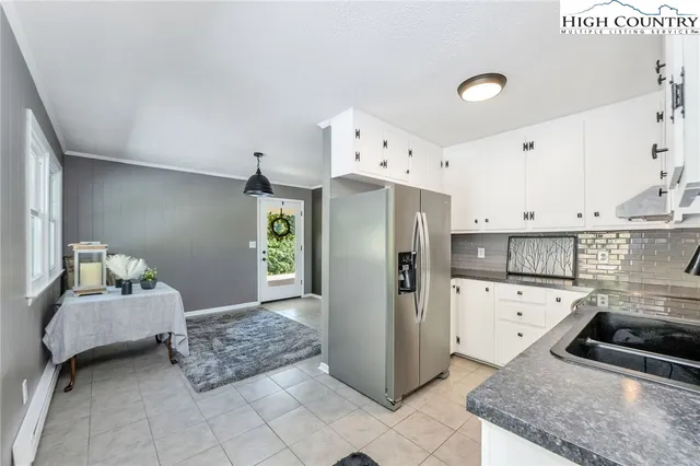 a kitchen with stainless steel appliances granite countertop a refrigerator and a stove