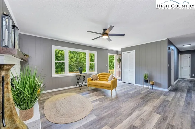 a view of a room with wooden floor and a ceiling fan