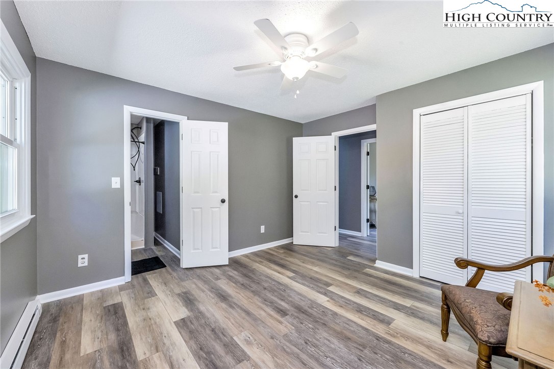 393 Carter Miller Road Todd, NC 28684 - Photo 29 of 50 a view of a room with wooden floor and a ceiling fan