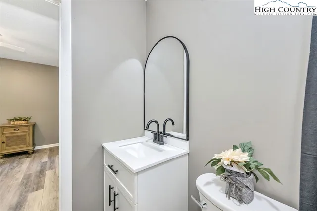 a bathroom with a toilet and a mirror