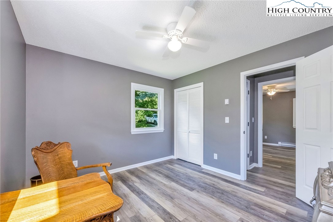 393 Carter Miller Road Todd, NC 28684 - Photo 37 of 50 a bedroom with a bed and a chandelier
