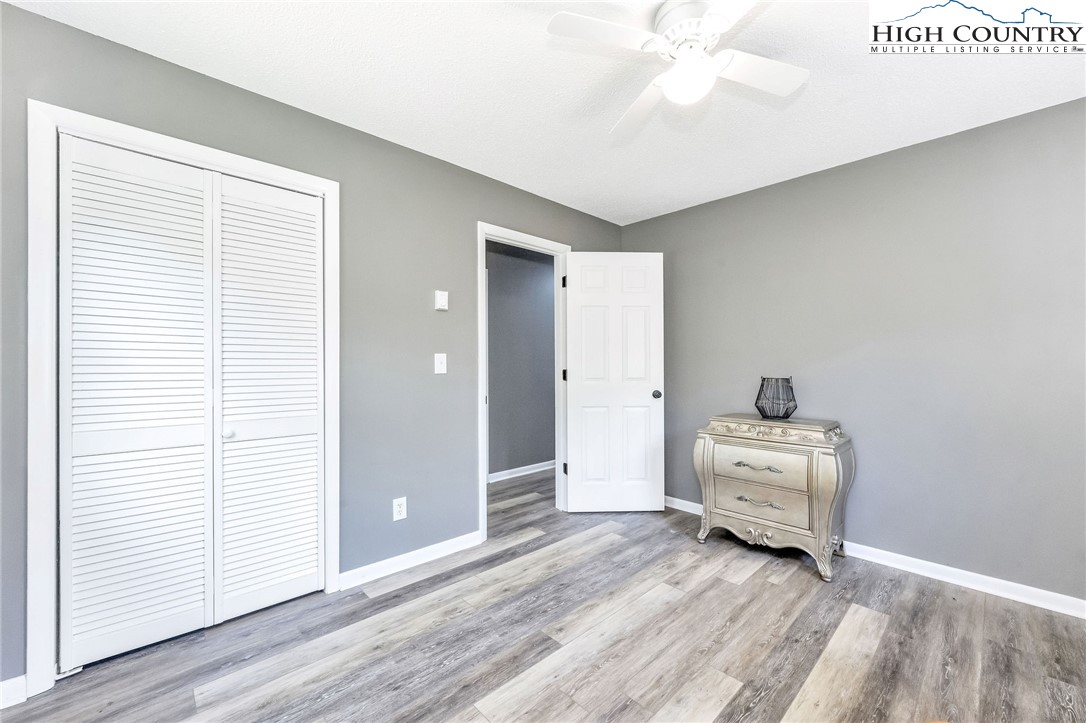393 Carter Miller Road Todd, NC 28684 - Photo 38 of 50 a view of room with hardwood floor and ceiling fan