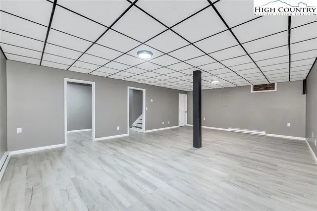 a bathroom with a sink shower and a mirror