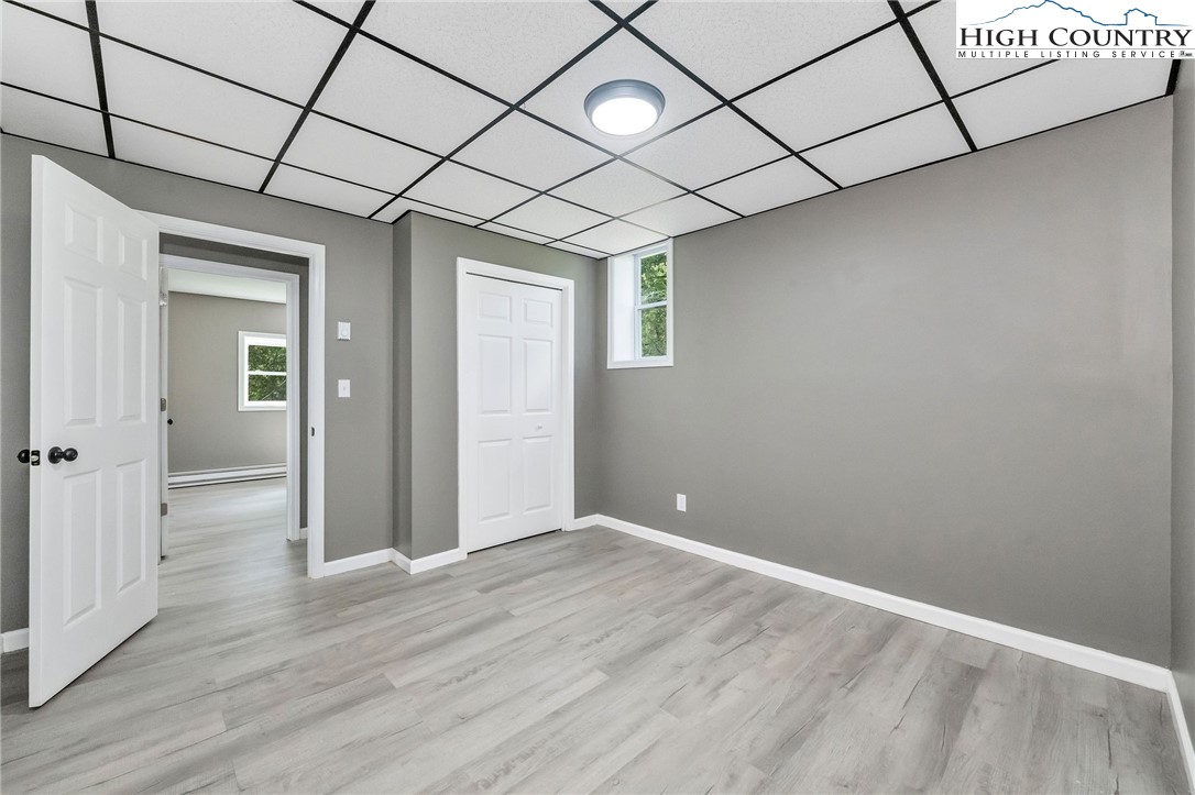 393 Carter Miller Road Todd, NC 28684 - Photo 48 of 50 wooden floor in an empty room with a window