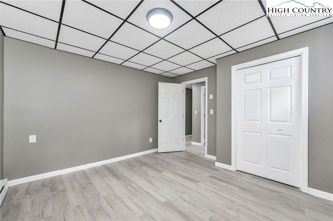 393 Carter Miller Road Todd, NC 28684 - Photo 49 of 50 a view of a room with wooden floor and brick walls
