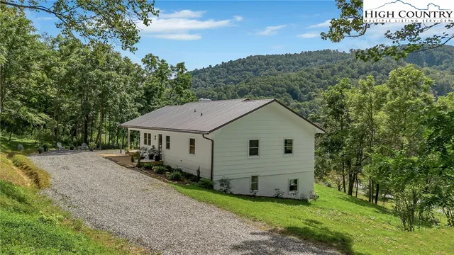 an aerial view of a house with yard
