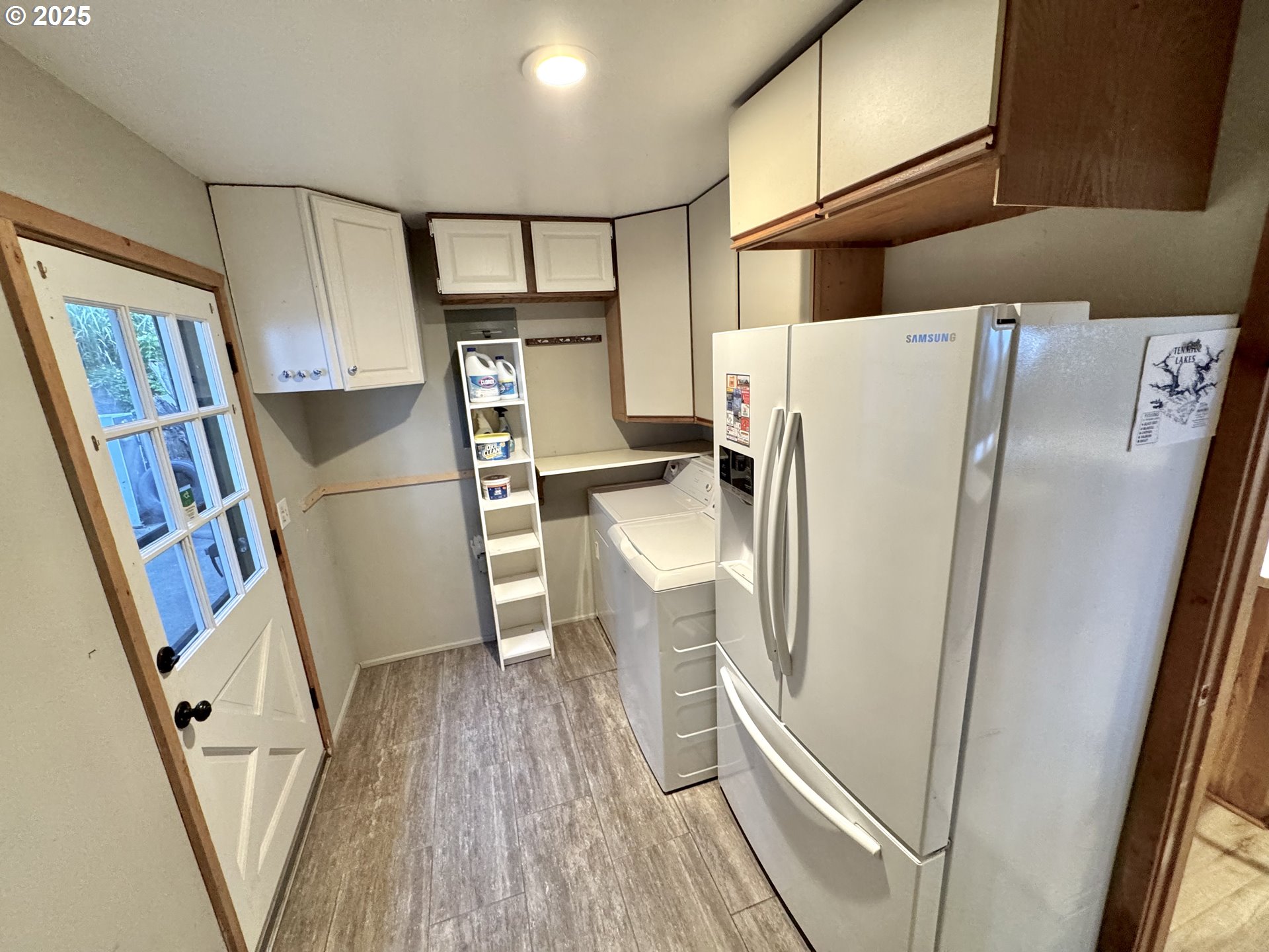70700 Majestic Shores Road North Bend, OR 97459 - Photo 13 of 48 a kitchen with stainless steel appliances a refrigerator and wooden floor