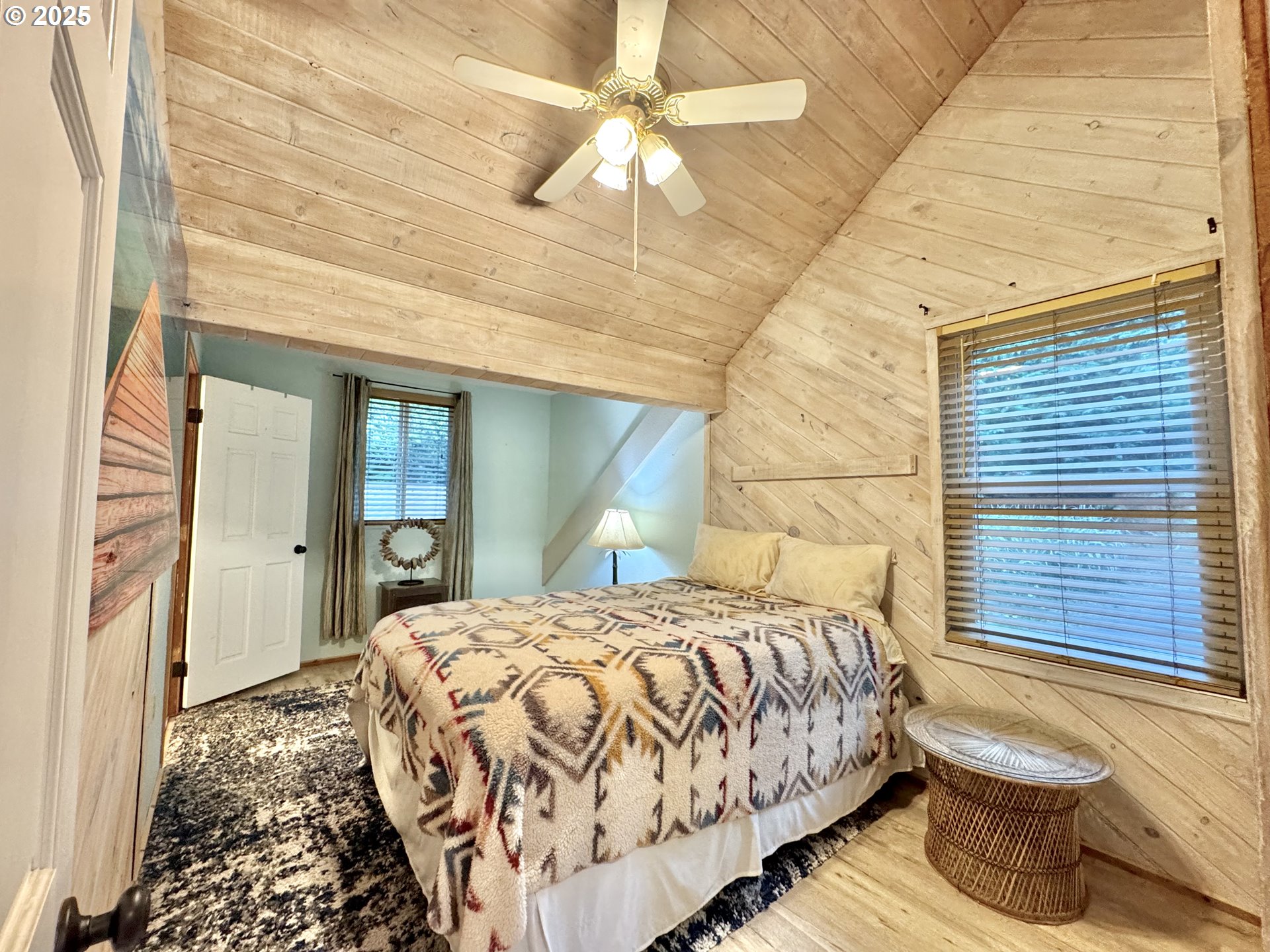 70700 Majestic Shores Road North Bend, OR 97459 - Photo 17 of 48 a bedroom with a bed and a chandelier