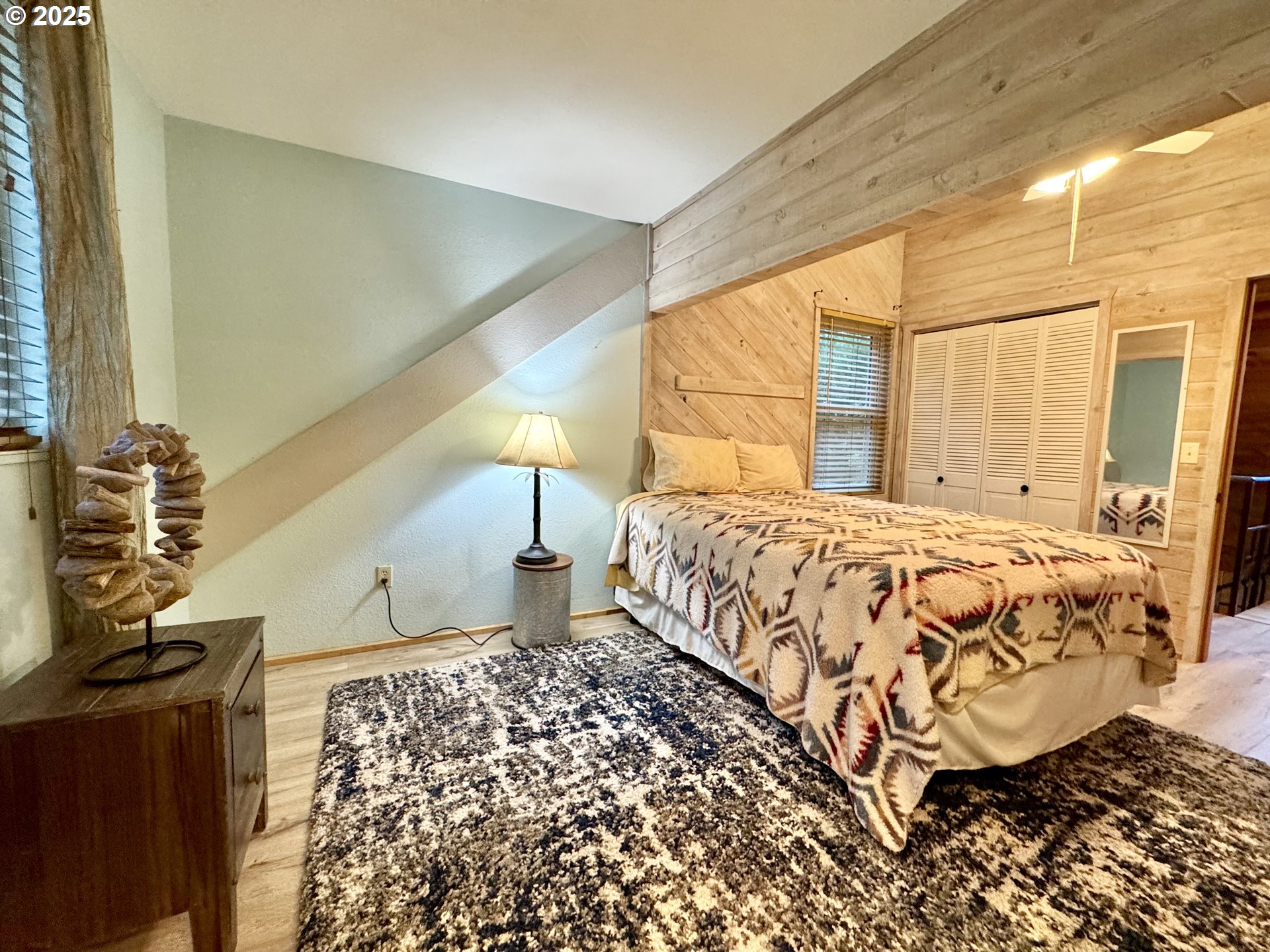 70700 Majestic Shores Road North Bend, OR 97459 - Photo 18 of 48 a bedroom with a bed and a window