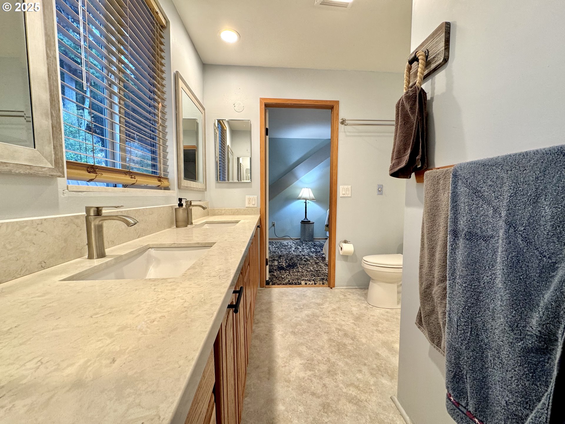 70700 Majestic Shores Road North Bend, OR 97459 - Photo 19 of 48 a bathroom with a granite countertop sink and a mirror
