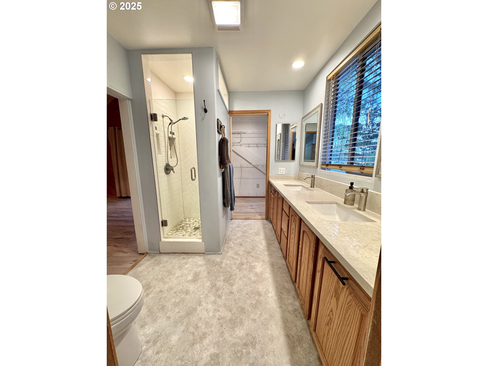 70700 Majestic Shores Road North Bend, OR 97459 - Photo 20 of 48 a bathroom with a granite countertop sink a mirror and a bathtub
