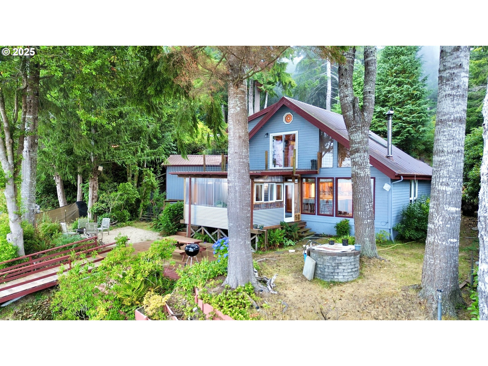 70700 Majestic Shores Road North Bend, OR 97459 - Photo 29 of 48 a view of a house with backyard and garden