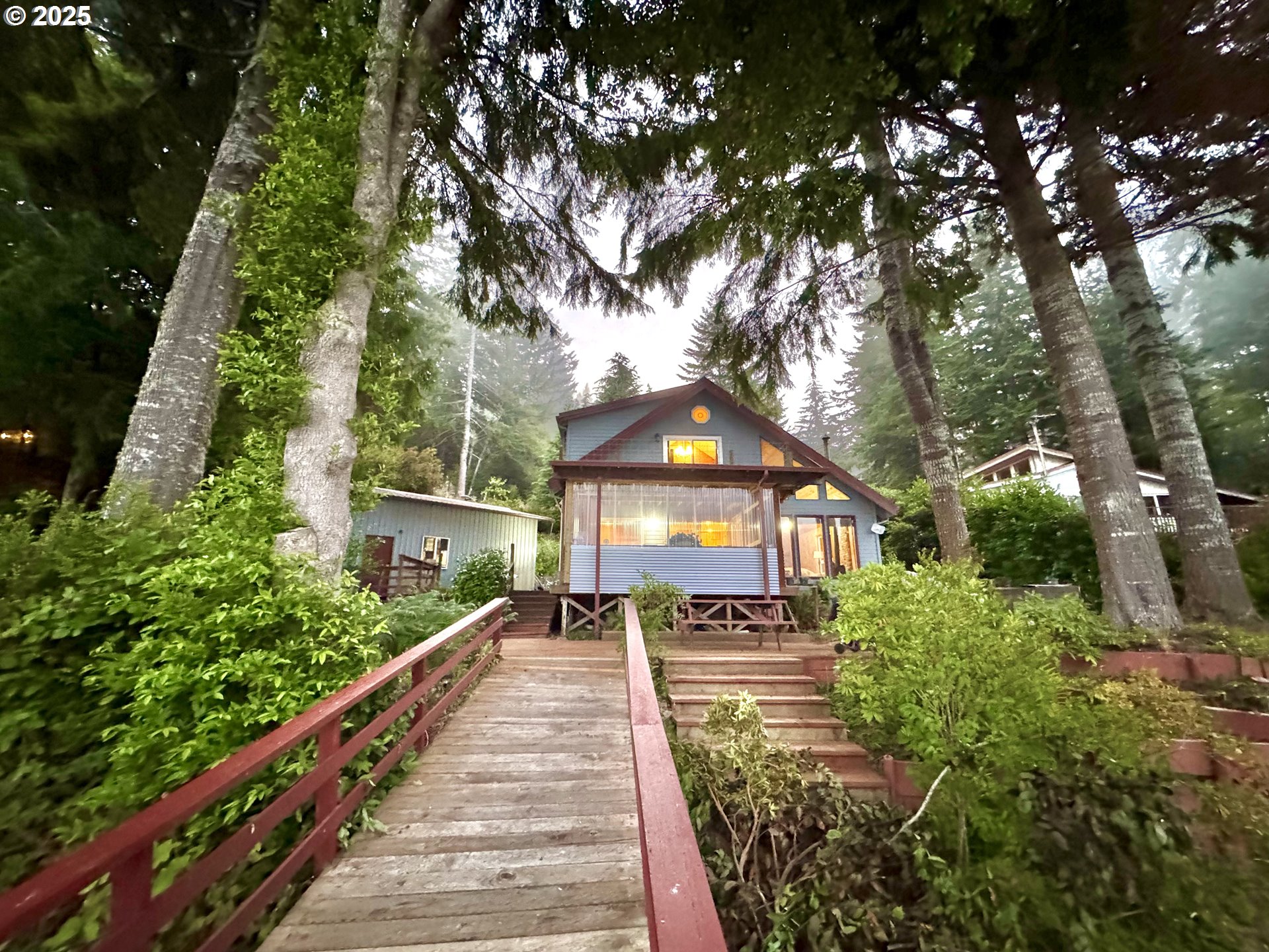 70700 Majestic Shores Road North Bend, OR 97459 - Photo 30 of 48 a view of a house with a yard