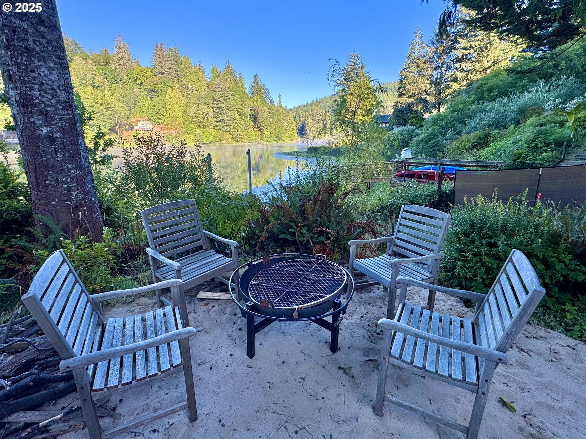 70700 Majestic Shores Road North Bend, OR 97459 - Photo 32 of 48 a view of an chair and table in backyard