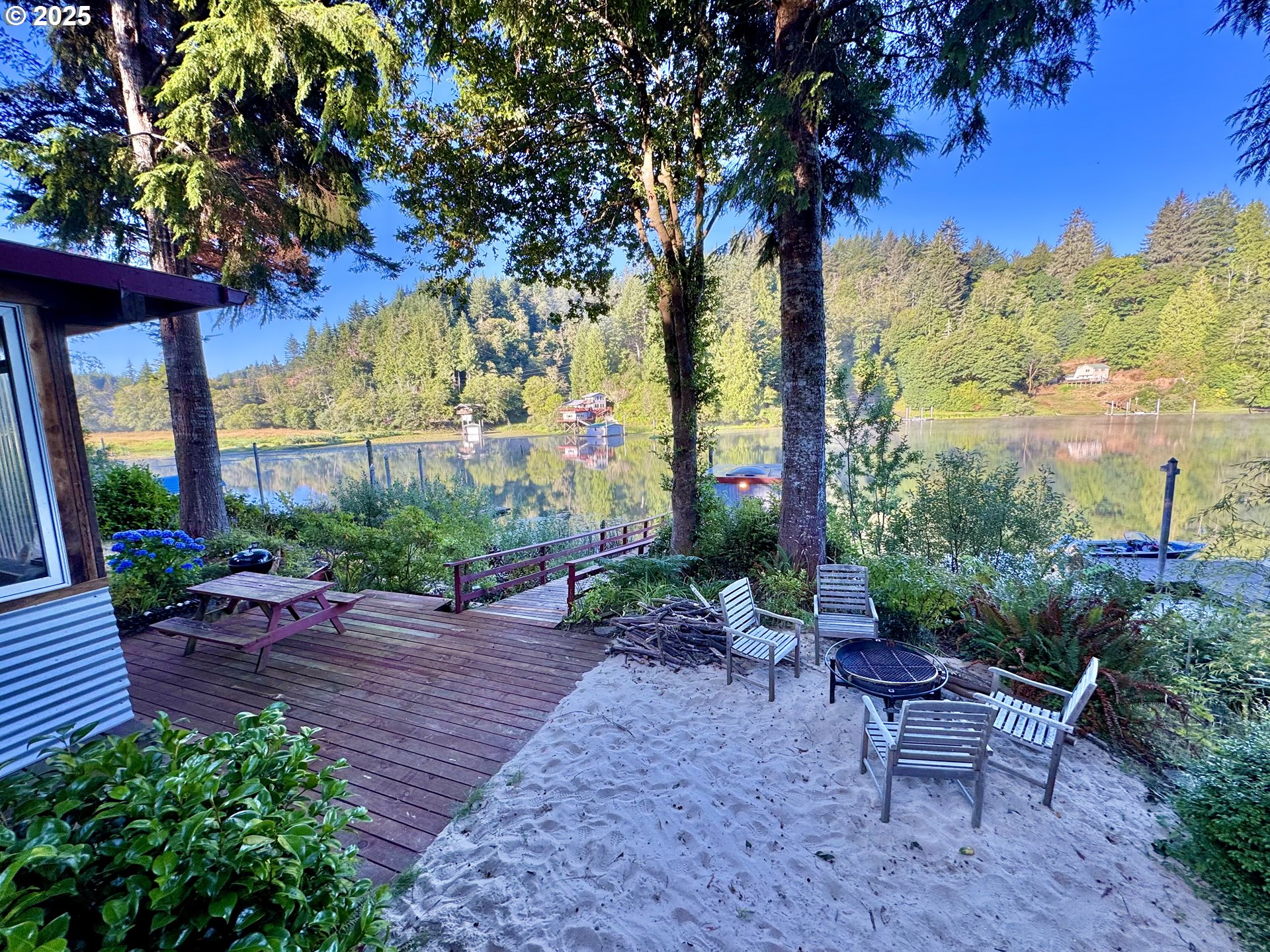 70700 Majestic Shores Road North Bend, OR 97459 - Photo 33 of 48 a view of a backyard with plants and a patio