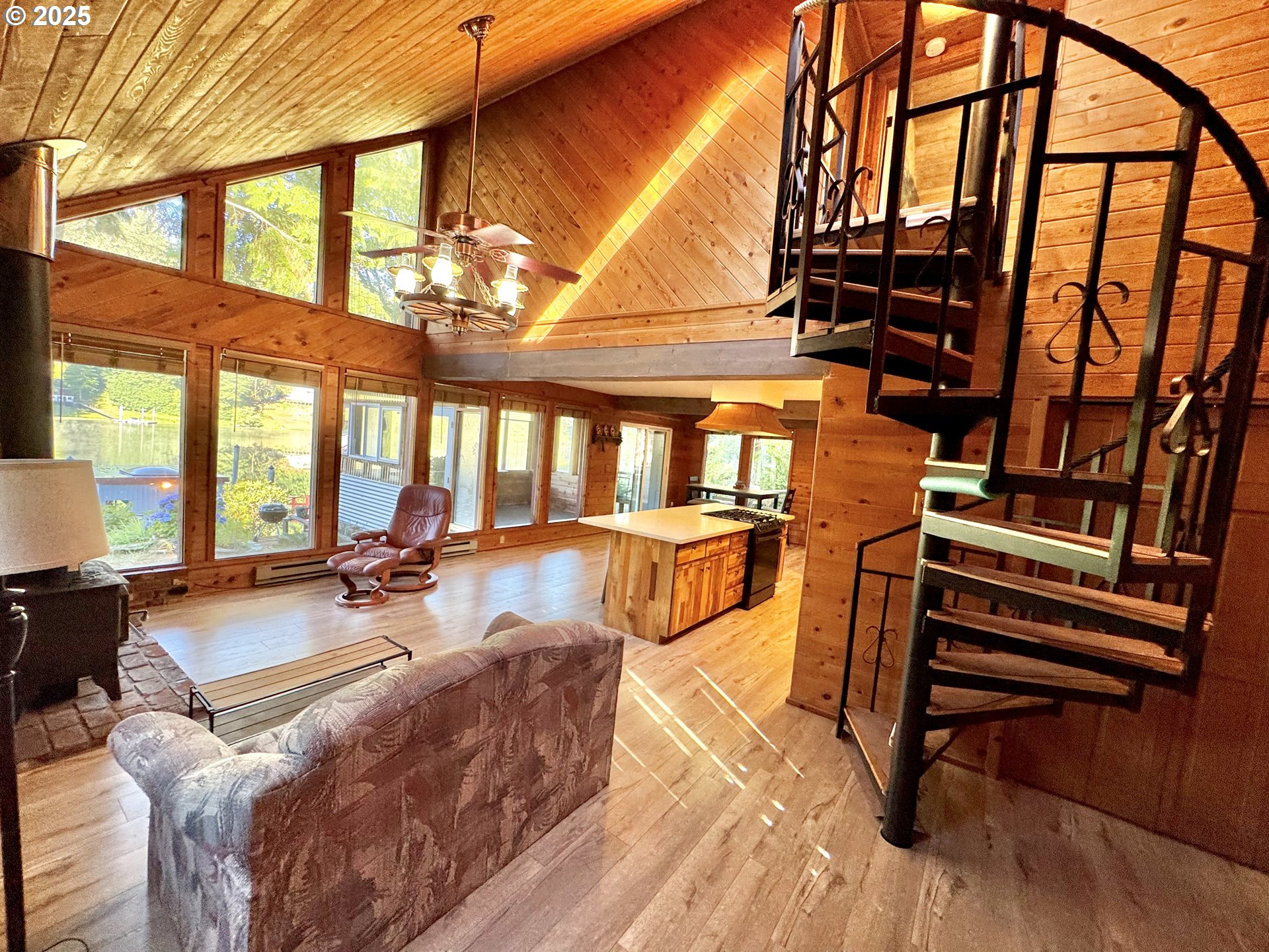 70700 Majestic Shores Road North Bend, OR 97459 - Photo 4 of 48 a view of a livingroom with furniture wooden floor and windows