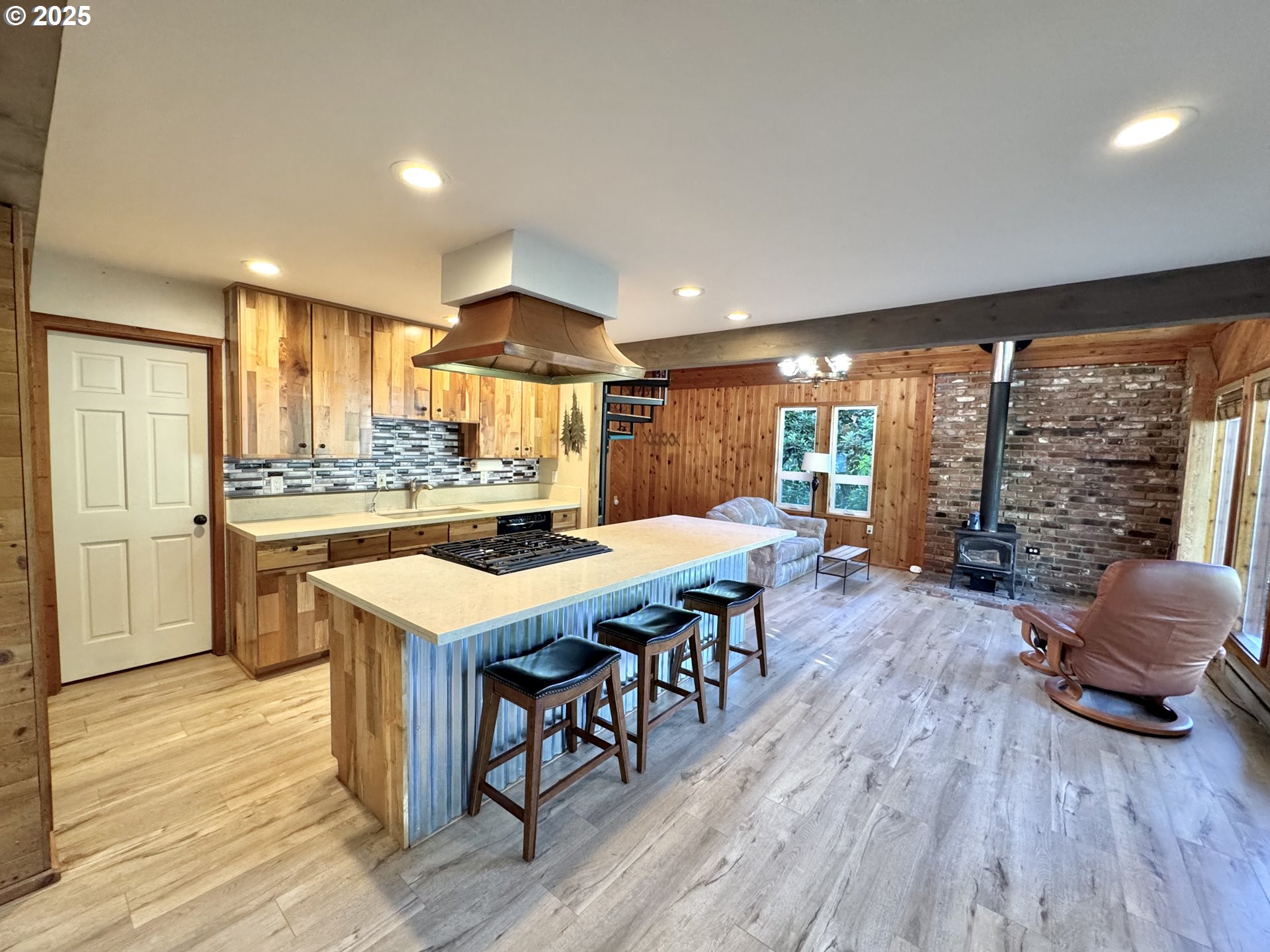70700 Majestic Shores Road North Bend, OR 97459 - Photo 6 of 48 a kitchen with a table chairs and wooden floor