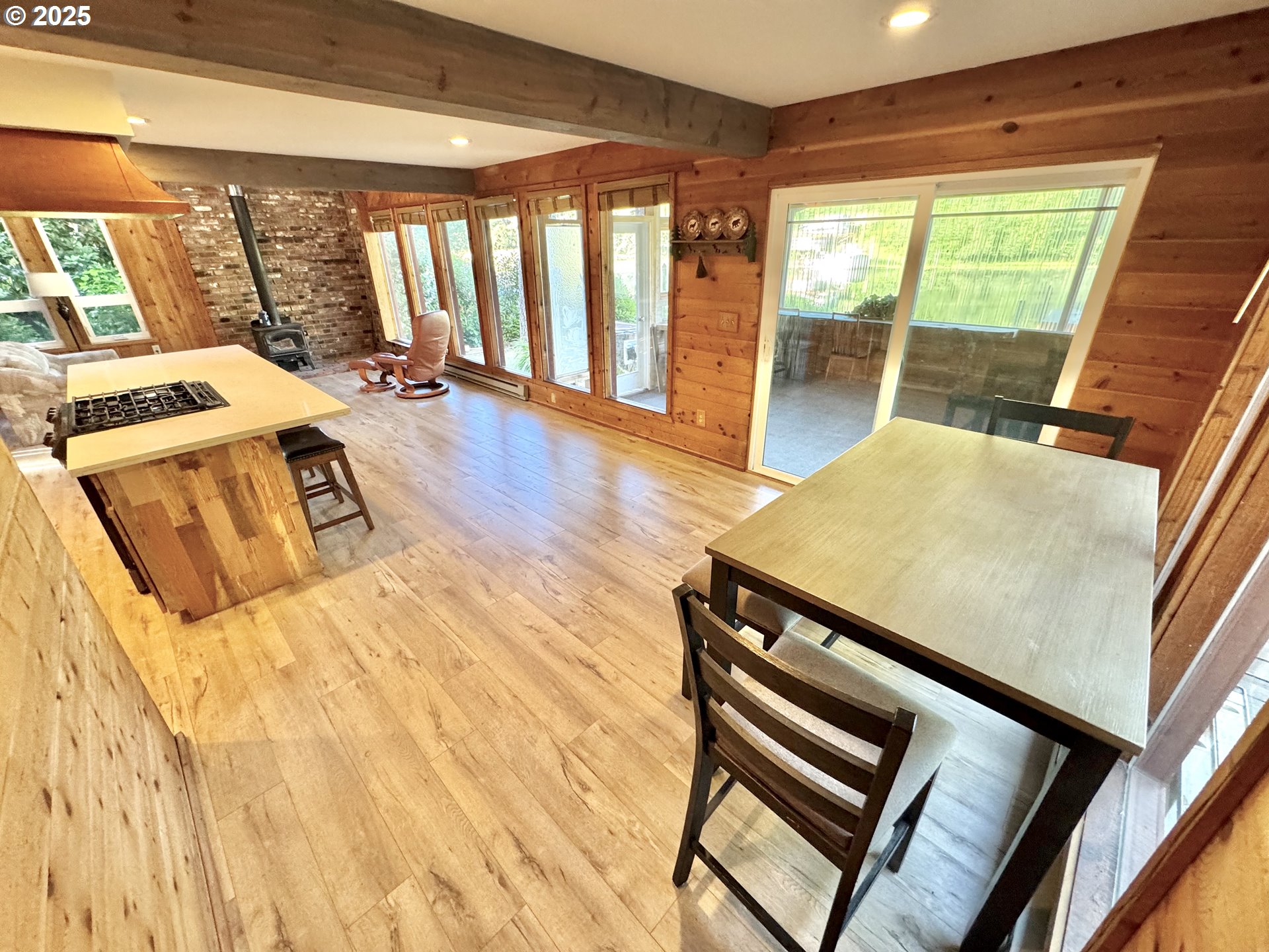 70700 Majestic Shores Road North Bend, OR 97459 - Photo 10 of 48 a view of an empty room with wooden floor and furniture