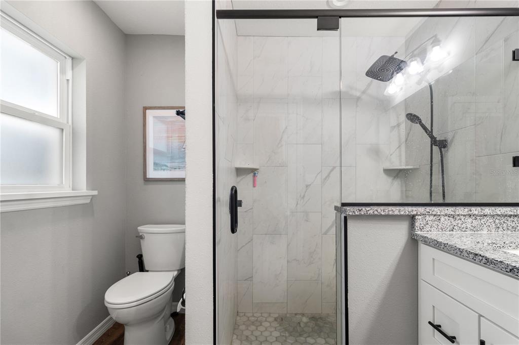 2545 Soundview Drive Dunnellon, FL 34431 - Photo 14 of 23 a bathroom with a granite countertop toilet and a shower