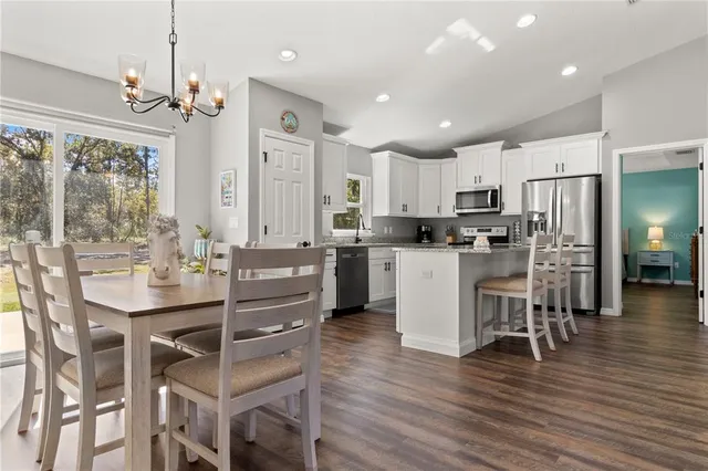 a large kitchen with stainless steel appliances granite countertop a large counter top and a stove top oven