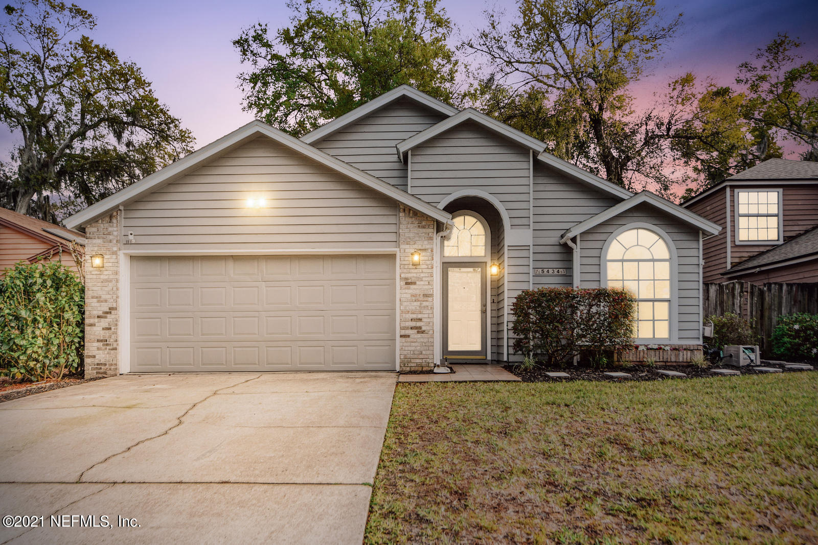 5434 Fort Caroline Road Jacksonville, FL 32277 - Photo 1 of 26 a front view of a house with a yard and garage