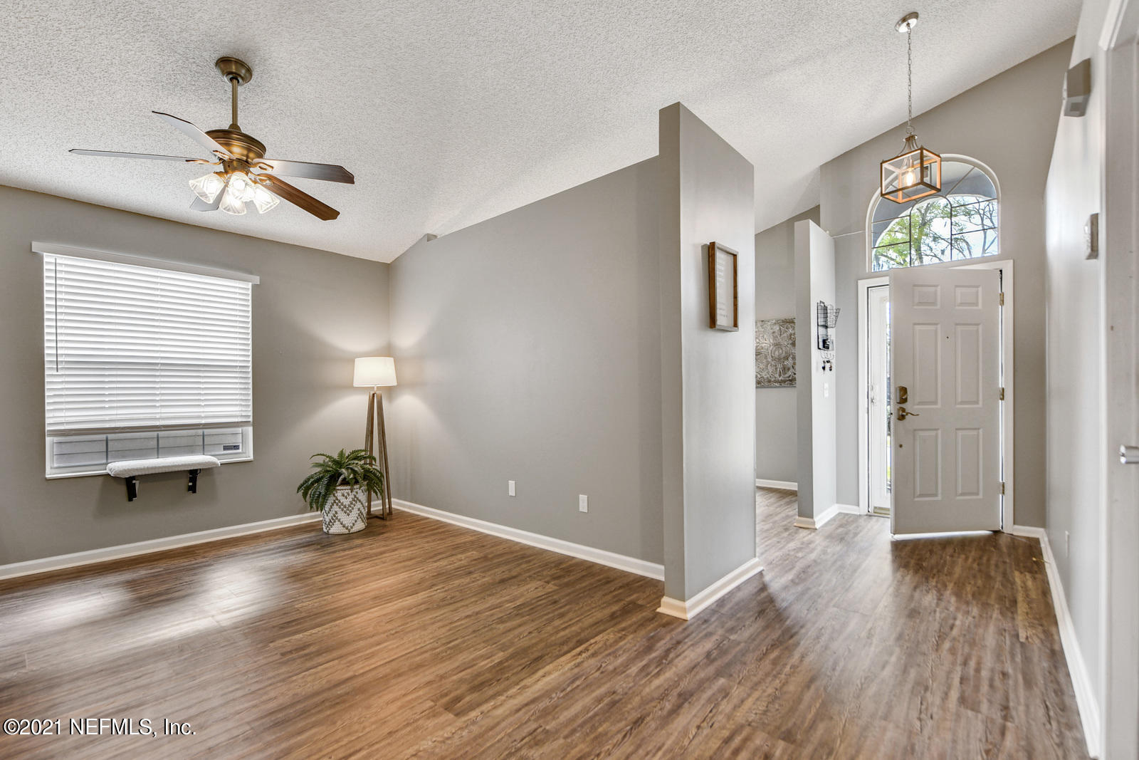5434 Fort Caroline Road Jacksonville, FL 32277 - Photo 10 of 26 a view of an empty room with a window and wooden floor