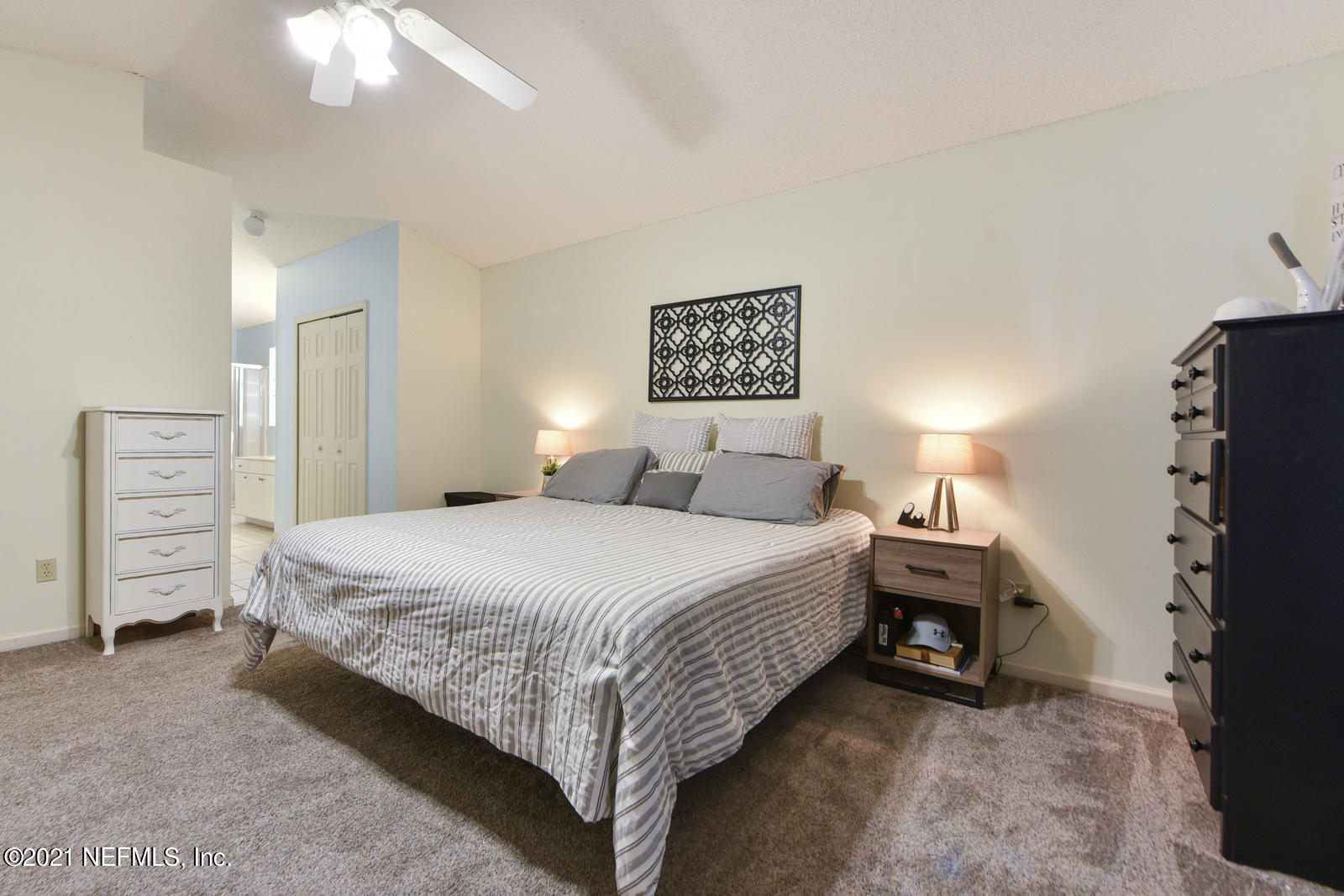 5434 Fort Caroline Road Jacksonville, FL 32277 - Photo 11 of 26 a bedroom with a bed and a chandelier