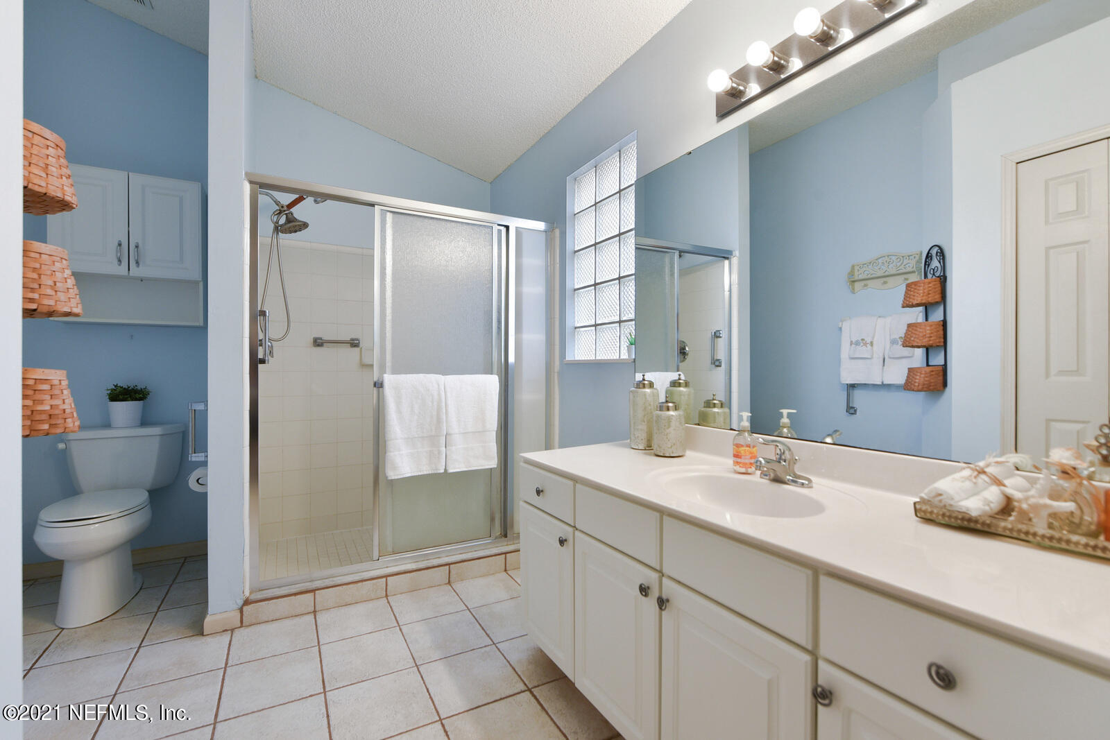 5434 Fort Caroline Road Jacksonville, FL 32277 - Photo 12 of 26 a spacious bathroom with a double vanity sink toilet and shower