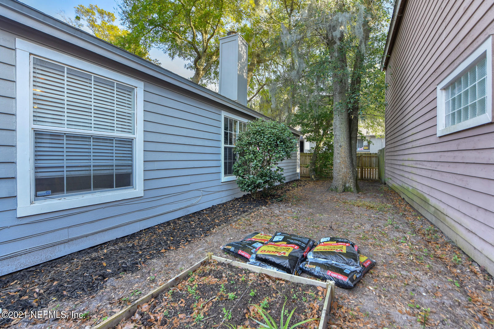 5434 Fort Caroline Road Jacksonville, FL 32277 - Photo 17 of 26 a view of a backyard with chairs and a table