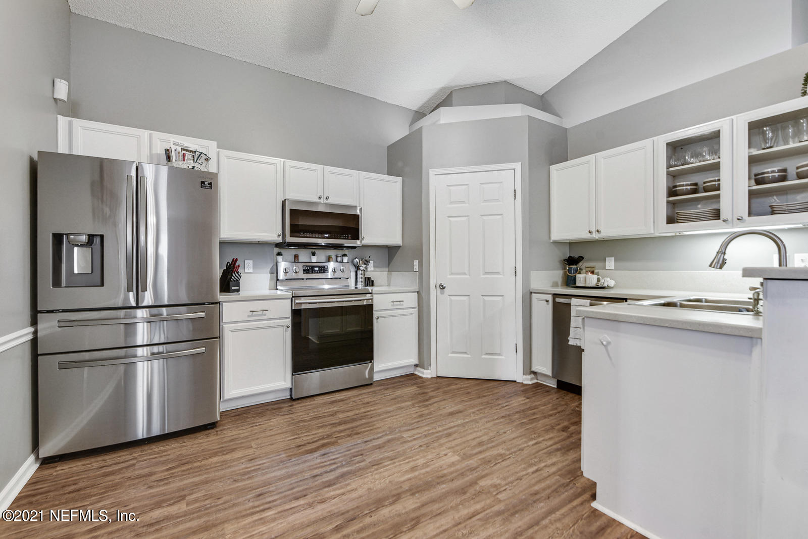 5434 Fort Caroline Road Jacksonville, FL 32277 - Photo 7 of 26 a kitchen with wooden cabinets and stainless steel appliances