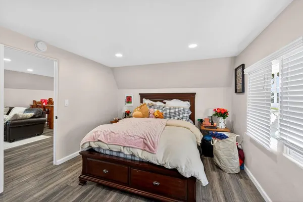 a bedroom with bed and a book shelf