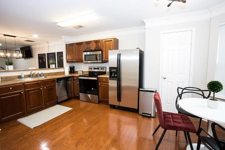 743 Crestwell Circle Atlanta, GA 30331 - Photo 6 of 20 a kitchen with stainless steel appliances a sink a stove a refrigerator cabinets and a dining table