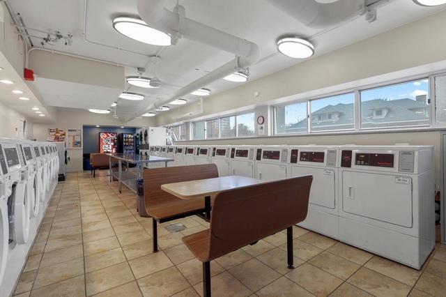 6171 North Sheridan Road, Unit 2502 Chicago, IL 60660 - Photo 20 of 28 a dining hall with stainless steel appliances kitchen island granite countertop a table chairs and a refrigerator