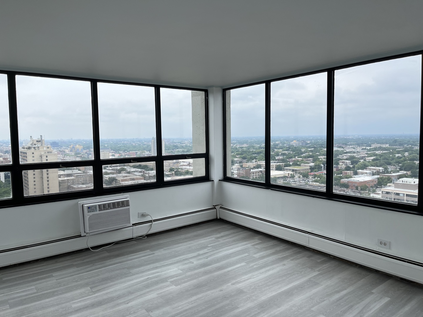 6171 North Sheridan Road, Unit 2502 Chicago, IL 60660 - Photo 6 of 28 a view of an empty room with wooden floor and a window
