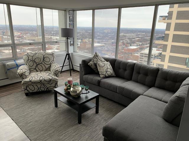 6171 North Sheridan Road, Unit 2502 Chicago, IL 60660 - Photo 7 of 28 a living room with furniture and a large window