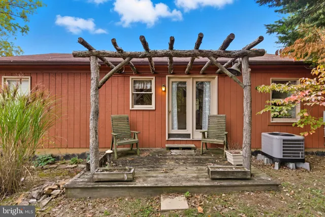 a view of outdoor space with wooden fence and trees