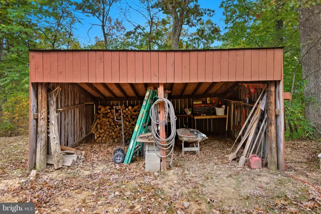 a view of a yard with wooden fence