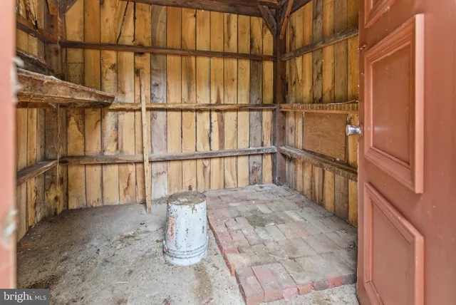 a view of a porch with furniture and floor to ceiling window