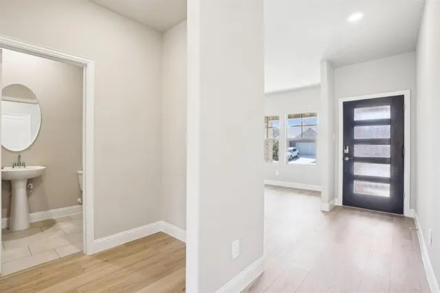 a view of an entryway with wooden floor