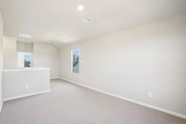 a view of an empty room and a window