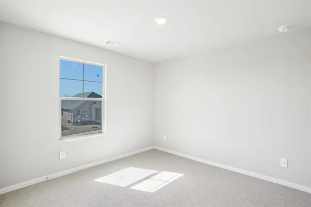 a view of an empty room and a window