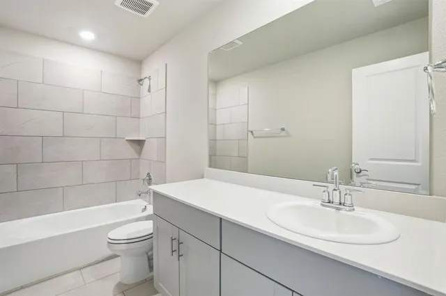 an empty room with a window and a ceiling fan